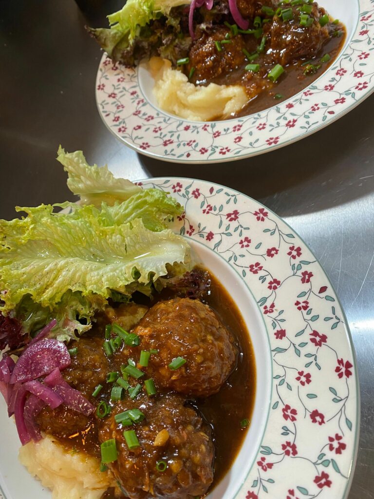 Assiette de boulettes en sauce avec purée et salade